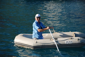 Anthony demonstrates the art of rowing a rubber dinghy minus its seat!