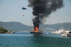 coastguard and helicopter combine to fight the blaze.