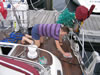 Sarah carefully cleaning the teak decks after our crossing of the Bay of Biscay.